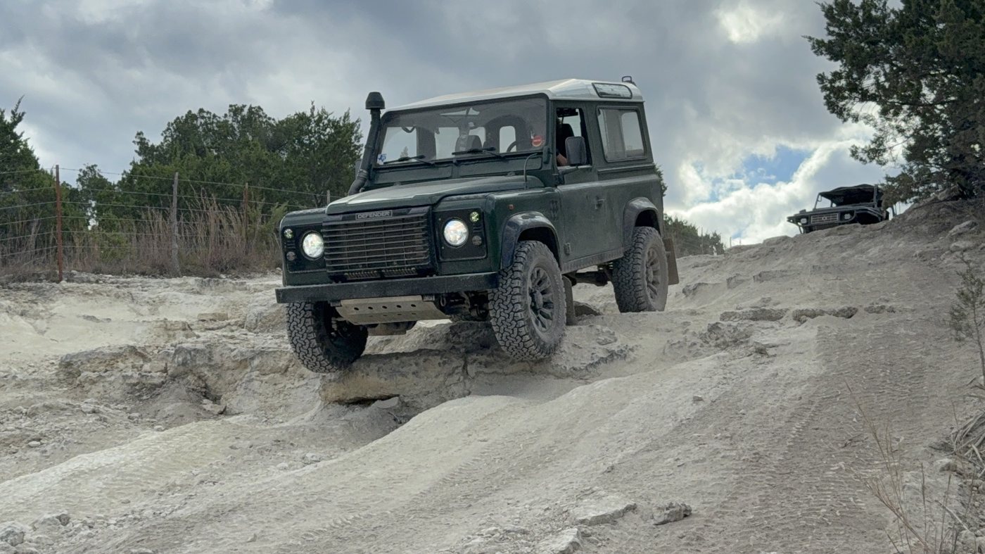 Defender crawling over rock in the Texas hill country