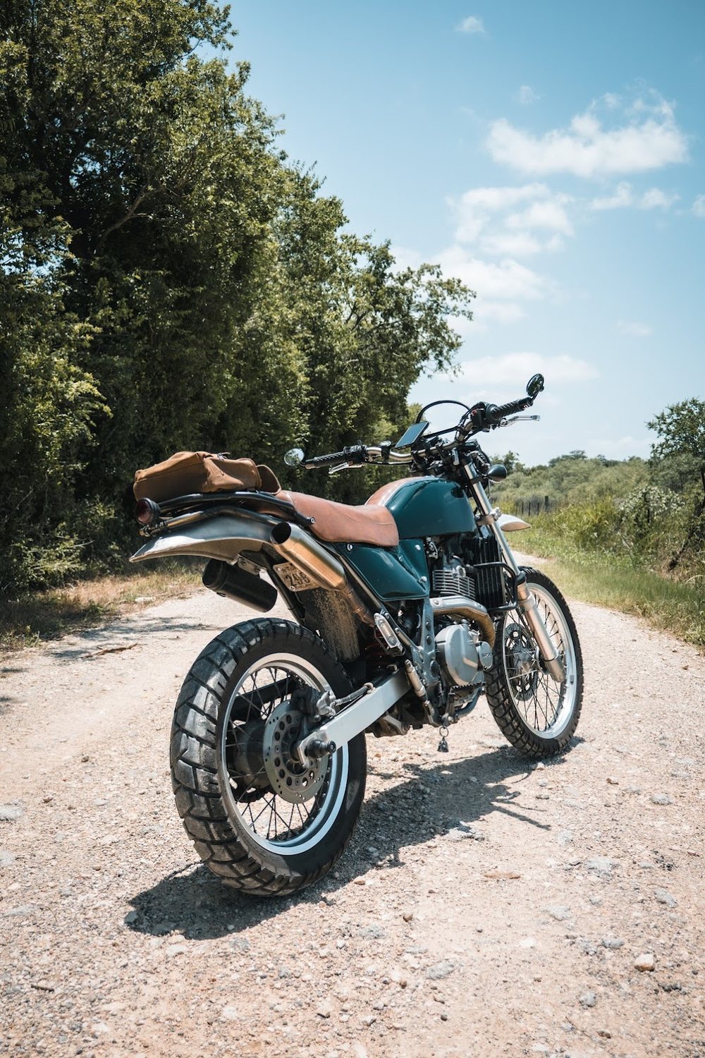 DR650 rear three-quarter on a gravel road